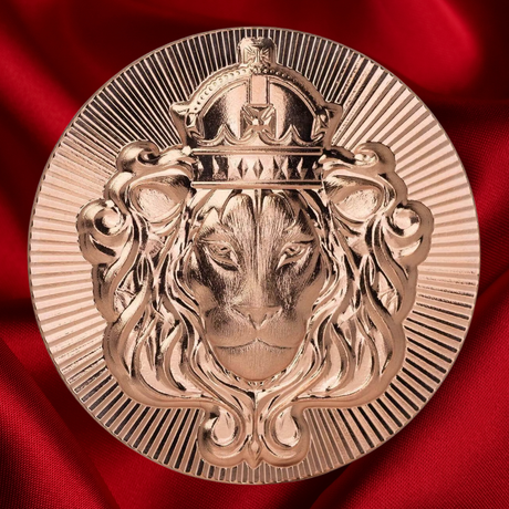 A circular metallic lion emblem with a crown, shown in a polished rose-gold or copper tone against a rich red satin fabric background.