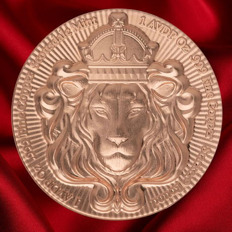 A round bronze-colored commemorative coin featuring a detailed lion face under a crown, displayed on a draped red satin fabric background. The Legend states the following : Scottsdale Mint 1` AVIDP oz .999 fine Copper
