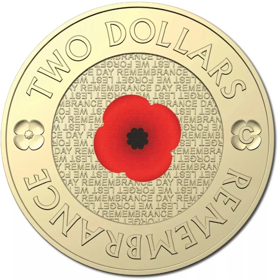 Two-dollar coin with a red poppy flower and engraved text on a gold background