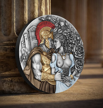 Decorative round piece with a classical design of a warrior and a woman, surrounded by roses, on a wooden surface.