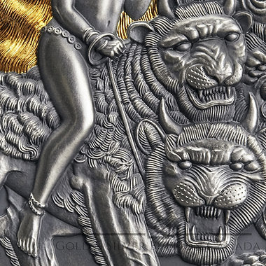 Close-up of a silver coin with a tiger and warrior design