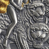Close-up of a silver coin with a tiger and warrior design