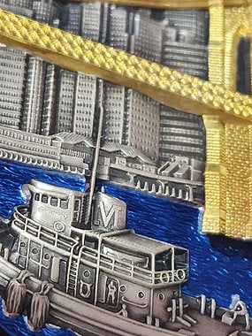 Metallic model of a ship with a cityscape background