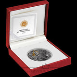 Silver coin with certificate of authenticity in a red box