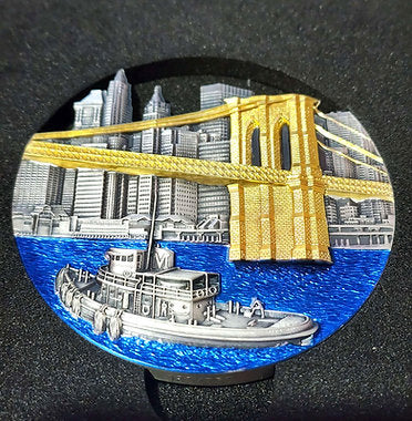 Decorative magnet with a cityscape, bridge, and boat on a black background