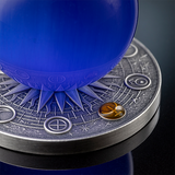 Close-up of Neptune’s blue cat’s-eye sphere and high-relief silver base with a digitally gilded astronomical symbol.