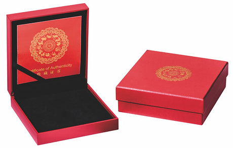 Red jewelry box with gold emblem and black interior on a white background
