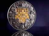 Decorative coin with intricate designs and a chessboard pattern on a dark background