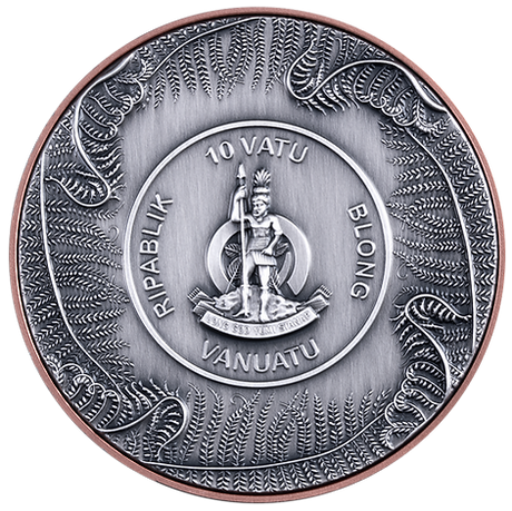 Silver coin with intricate designs and text, featuring a central emblem and surrounding patterns.