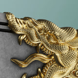 Gold dragon design on a gray surface with a light blue background