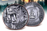 Two silver coins with a Smilodon design and Vanuatu emblem against a forest background.