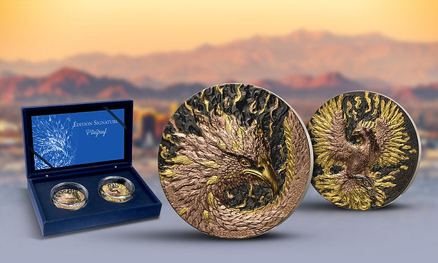 Two gold coins with an eagle design on a blue stand against a mountainous landscape.