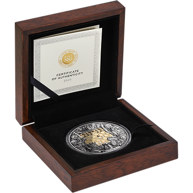 Silver coin with gold accents in a wooden box with a certificate of authenticity.