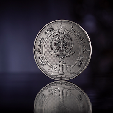 Silver coin with detailed design on a reflective surface