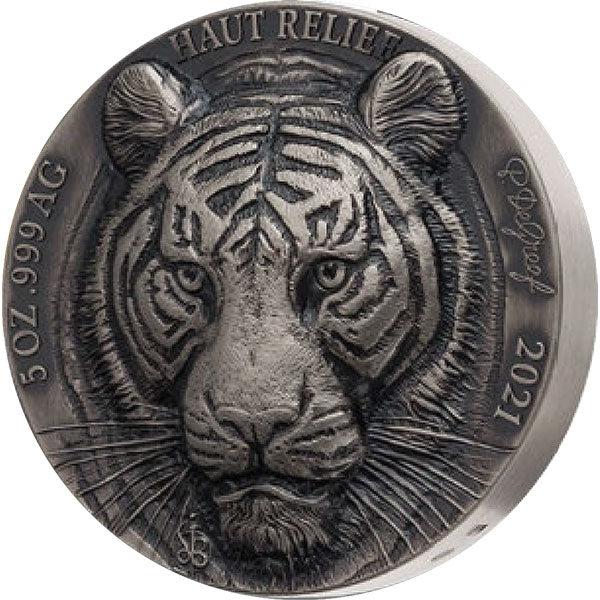 Silver coin with a tiger face design and 'Haut Relie' text