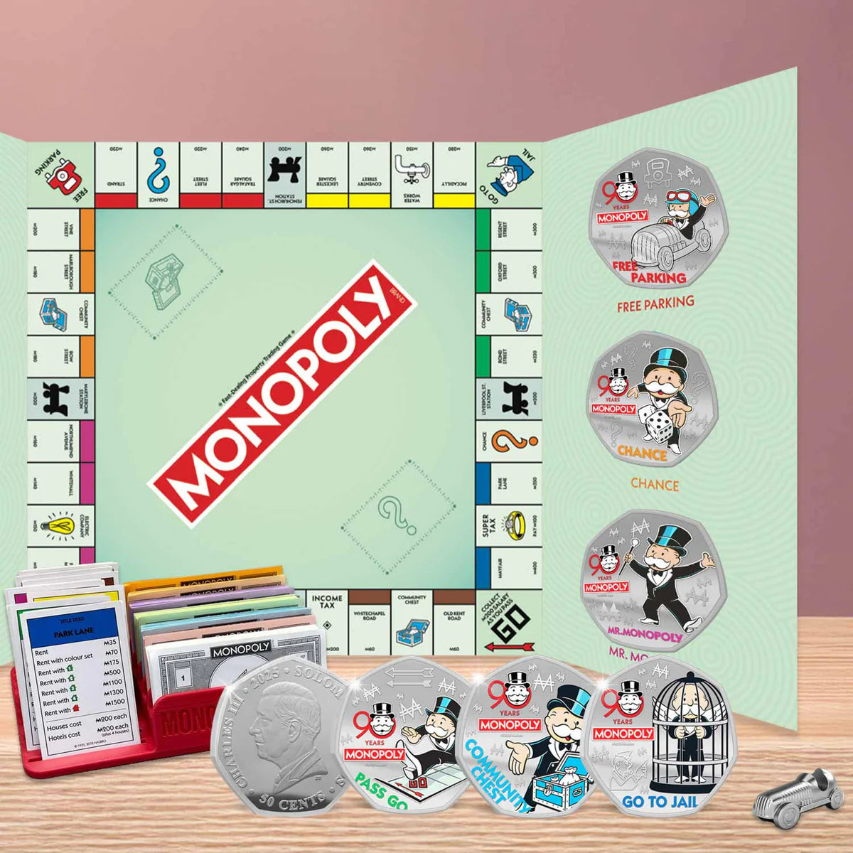 Monopoly game board with pieces and cards on a wooden surface