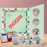 Monopoly game board with pieces and cards on a wooden surface