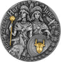 A circular silver coin featuring relief images of Hera and Juno with a gilded finish of a flower topped staff and a bull's head on a shield. Greek classical patterns adrn the edge of the face of the coin.