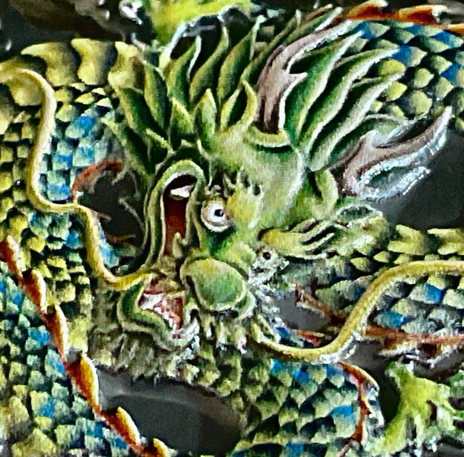 Close up of Green snarling Dragon's Head on Double Dragon DoubleTiger Coin reverse 