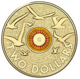 Reverse: Flying birds over textured lettering, surrounding an orange ring and central C mintmark.