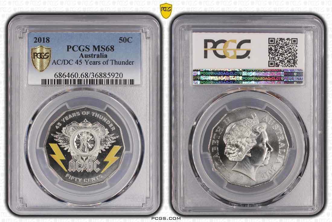 2018 Australian AC/DC 45 Years of Thunder 50c coin in a PCGS MS68 holder, showing the coloured reverse with yellow lightning bolts and Queen Elizabeth II obverse