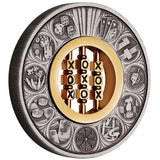 Reverse design of the 2022 2oz silver antiqued coin by The Perth Mint. The outer ring showcases highly detailed matte silver engravings of classic games—including playing cards, dominoes, a spinning die, chess pieces, snakes and ladders, mahjong tiles, backgammon, and knucklebones. Deep gray shadows from the antique finish highlight the details. The centerpiece holds a functioning, 24-carat gold-plated stainless steel 'Noughts and Crosses' game insert with turning cubes.