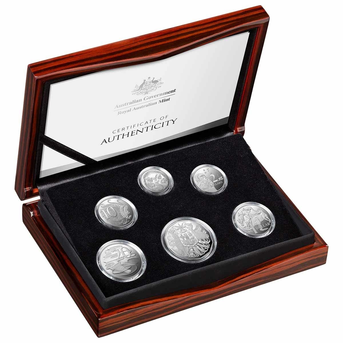 A set of six fine silver coins from Australia, presented in a proof set format, displayed in a case with a wooden exterior and a black interior. The coins are arranged in two rows with three coins visible in each row.