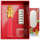 Open box: Gingerbread Man PEZ dispenser and six silver wafers with the printed reverse-proof certificate.