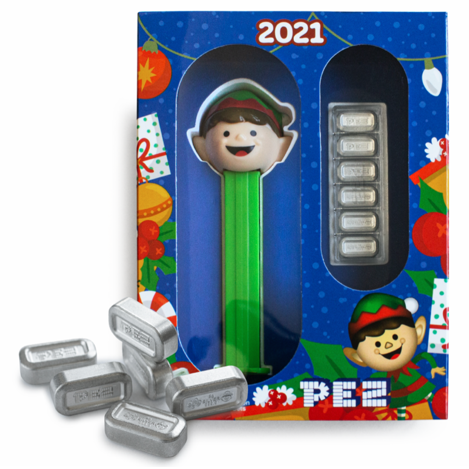 Gift set front: Austria 2021 PEZ Elf gift set in blue Christmas packaging, showing the green-stemmed Elf dispenser, six silver wafers in a clear holder and loose wafers in front.