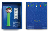Open box and printed certificate: 2021 PEZ Elf gift set opened to show the Elf dispenser, wafer holder and printed certificate, with the PAMP-branded box back.