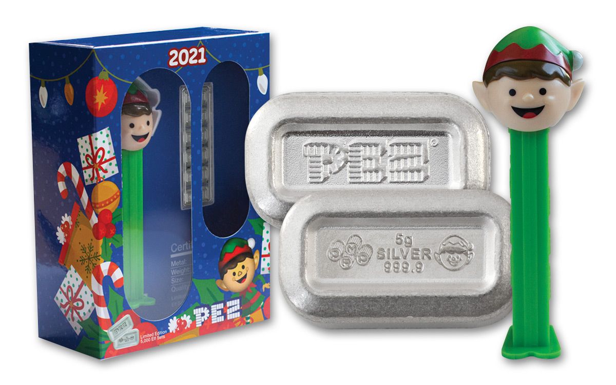 Wafer detail with dispenser and box: Close view of the 2021 PEZ Elf 5 g silver wafers, one face showing the PEZ logo and the other marked 5g SILVER 999.9, beside the Elf dispenser and festive box. Not to scale.