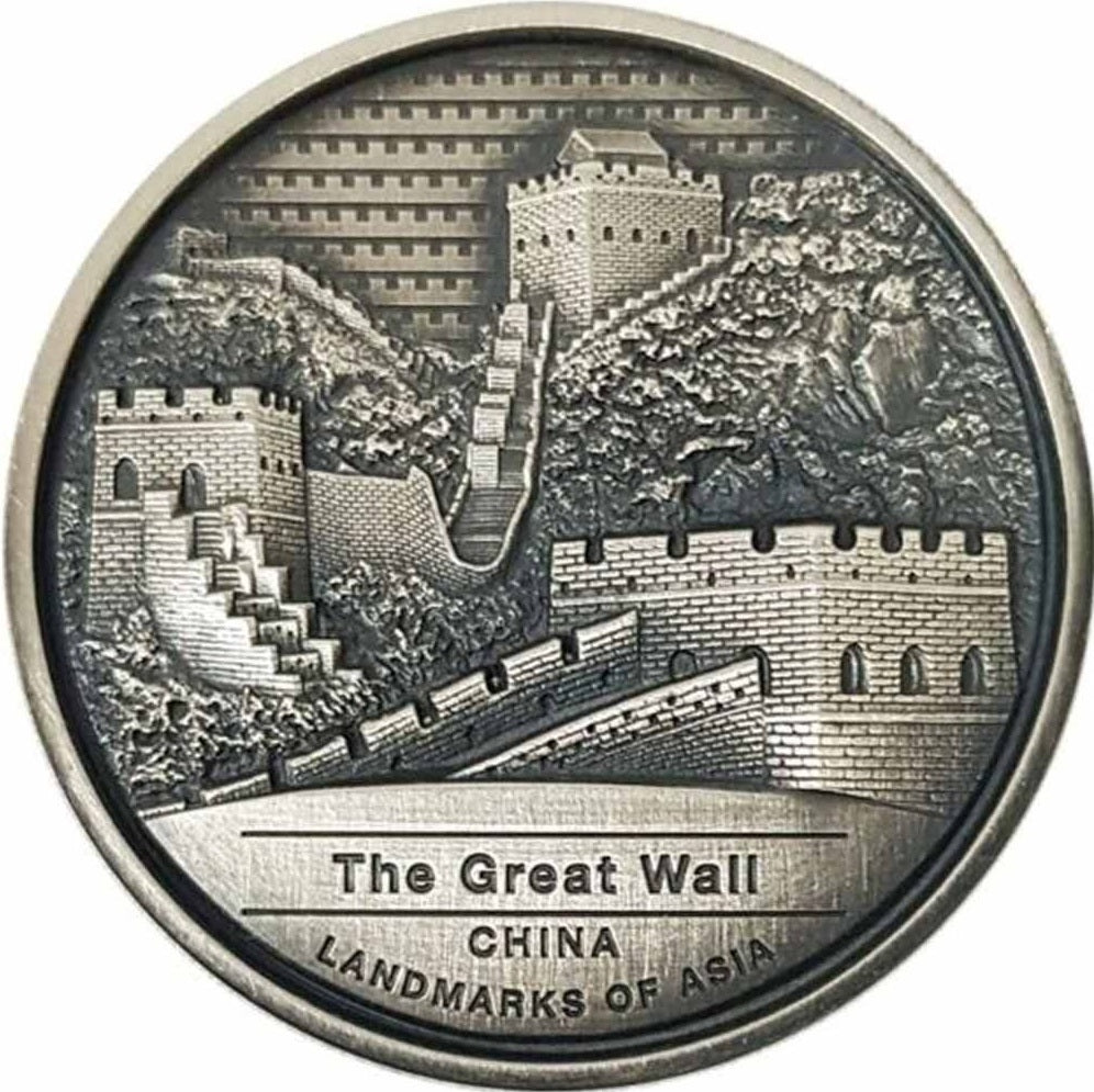 A silver coin featuring the Great Wall of China with high relief and antique finish, labeled as legal tender in Cambodia.