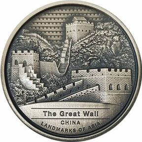 A silver coin featuring the Great Wall of China with high relief and antique finish, labeled as legal tender in Cambodia.