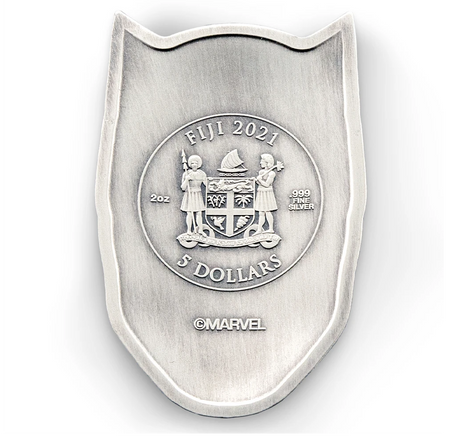 Fiji 2021 $2 Black Panther Mask 2oz Antiqued Silver Coin Perth Mint - A shield-shaped silver coin featuring the Fiji 2021 5 Dollars emblem, displayed on a rich red satin fabric background. The coin is made of silver with a brushed finish and a raised central seal.Obverse
