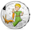 A silver proof coin featuring 'The Little Prince' and a fox on one side, with stars and a planet in the background. The coin has a face value of 10 Euros and is a collectible item.