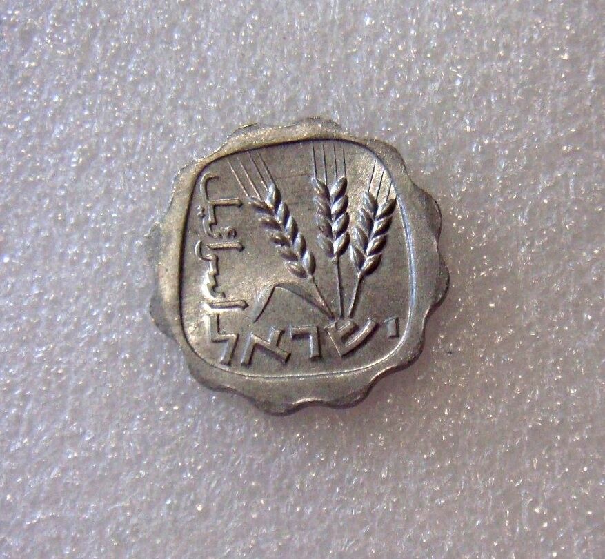 A silver-colored collectible coin with agricultural imagery on the reverse side, on a light background.