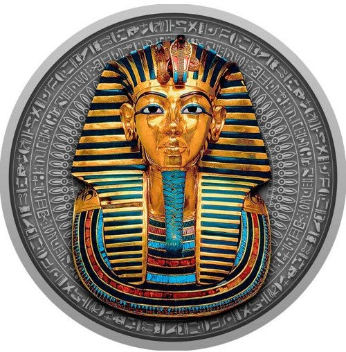 A close-up view of the detailed reverse side of the Niue 2022 2-ounce silver coin. The high-relief antiqued design centers on the legendary death mask of Pharaoh Tutankhamun, intricately embellished with selective yellow-gold gilding and deep blue accents on the nemes headdress. The top features the protective uraeus cobra and vulture symbols, while a traditional artificial beard accents the chin. The entire mask is framed by an etched border of historic Egyptian hieroglyphics.
