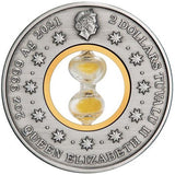 A round silver commemorative coin featuring a central clear glass hourglass filled with gold sand. The coin is inscribed with '2 DOLLARS TUVALU II QUEEN ELIZABETH II 9999 Ag 2021' and features a profile of Queen Elizabeth at the top with a garand of 11 stars circling the coin toward her.