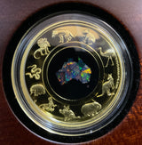 Australia 2022 $200 Great Southern Land 2oz Gold Proof Opal Coin. Reverse in Wooden Caseshowing Opal in different lighting.